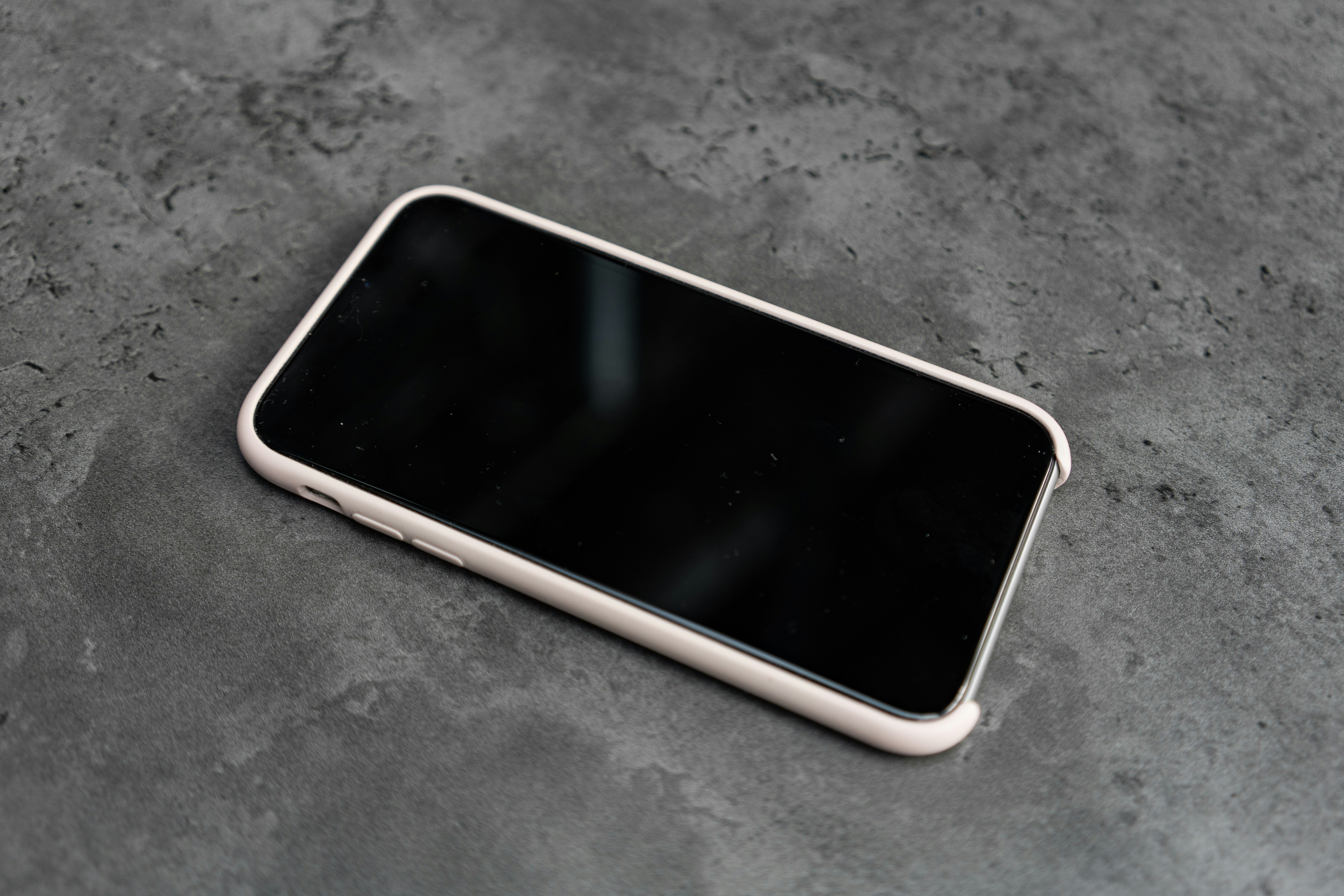 white smartphone on gray textile