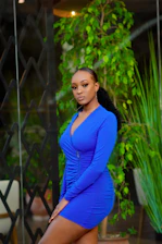 Portrait of Daniela Puertas speaking confidently in a professional setting with blue and gold accents.