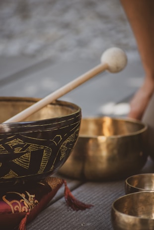 brown wooden stick on blue and white ceramic bowl