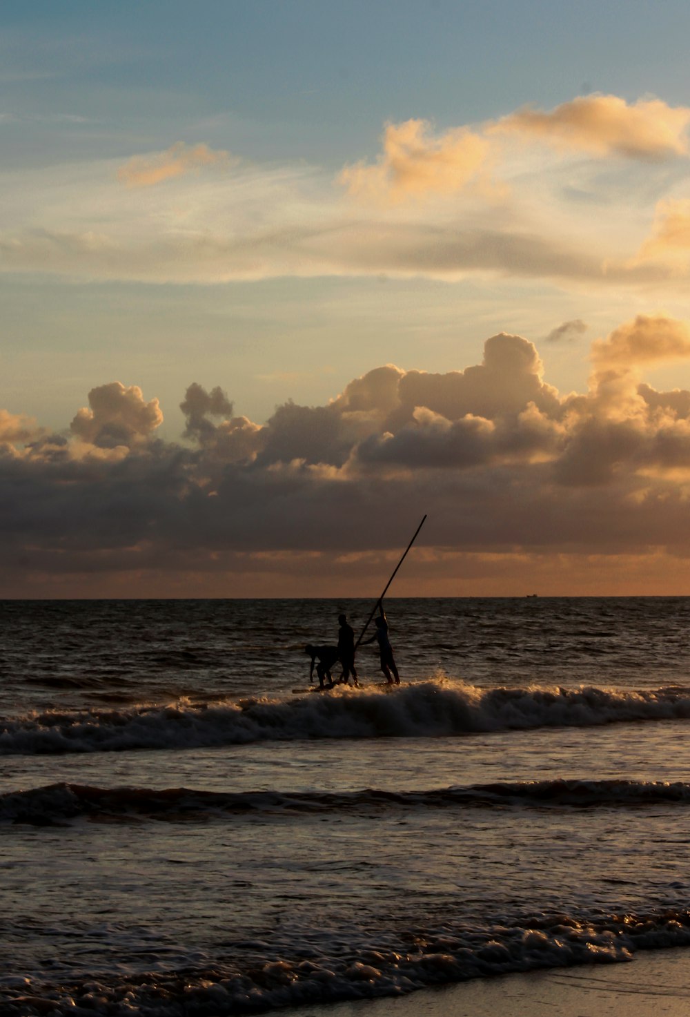 silhouette of person riding on boat on sea during sunset