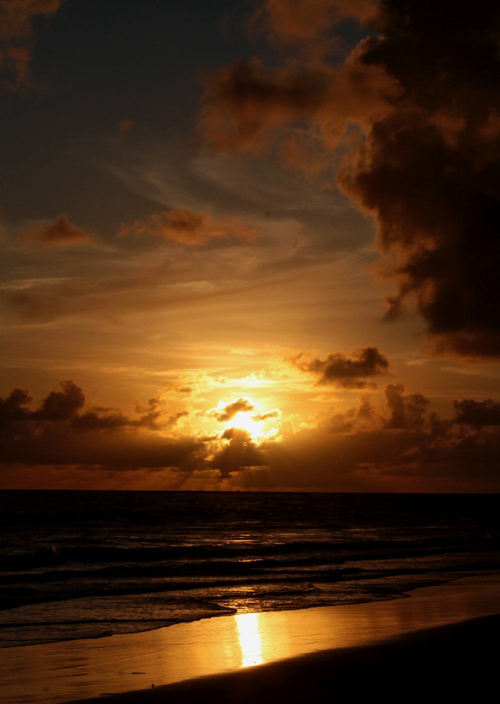 sea waves crashing on shore during sunset