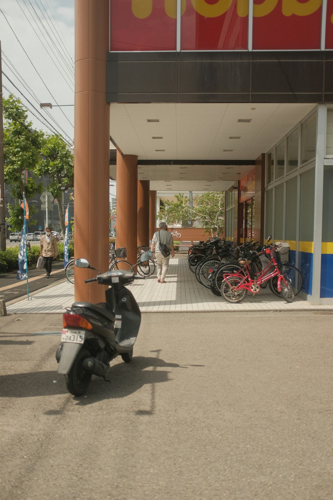 black and gray motorcycle parked beside brown building during daytime