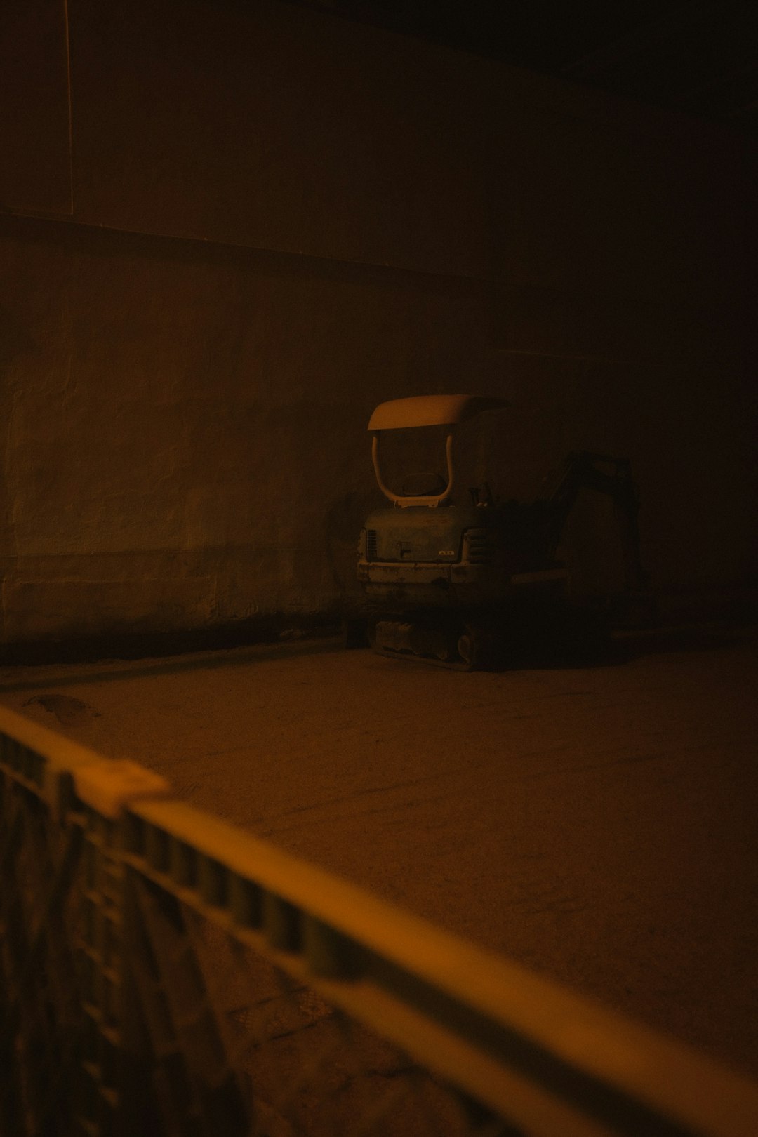 white and black car parked beside wall