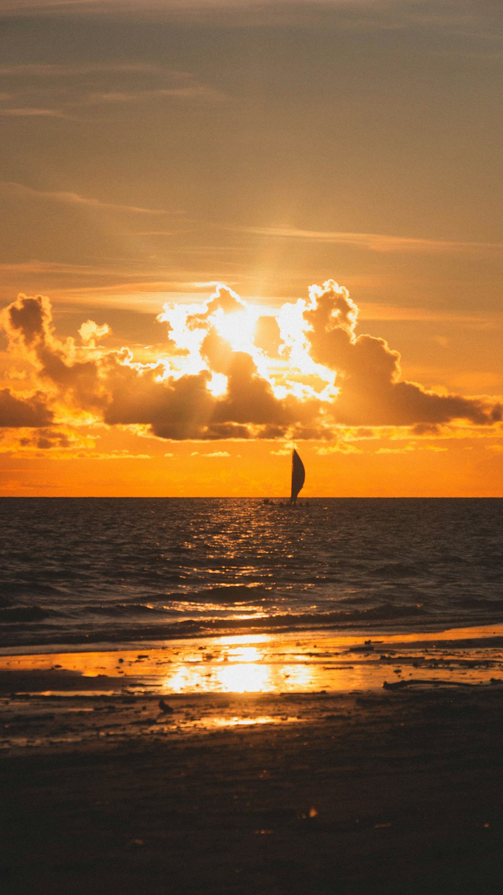silhouette of person surfing on sea during sunset