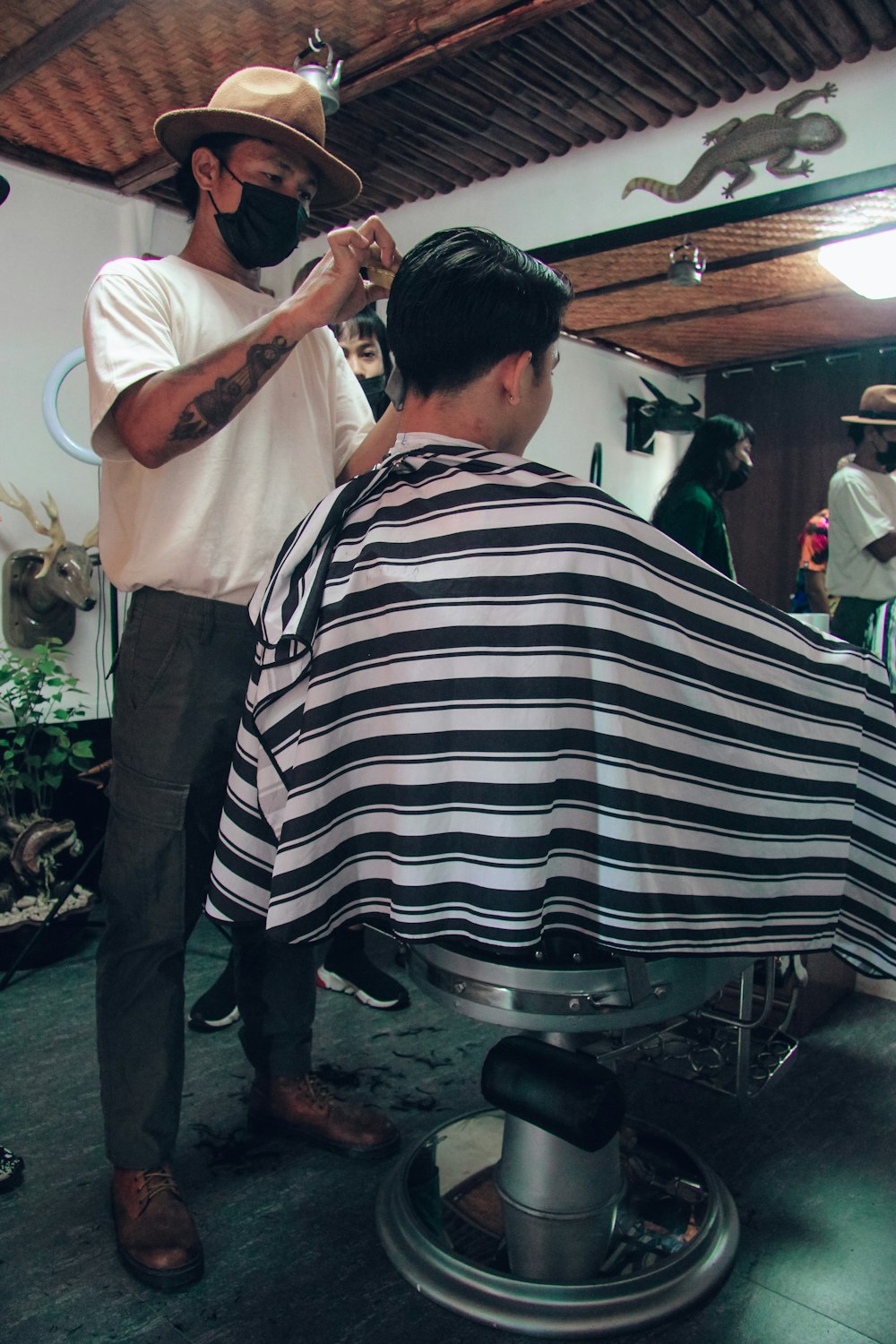 man in white shirt and black and white stripe pants standing near man in white shirt