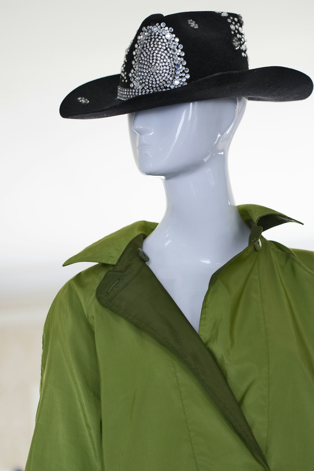 woman in green button up shirt wearing black hat