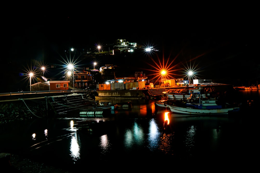 boat on water near dock during night time