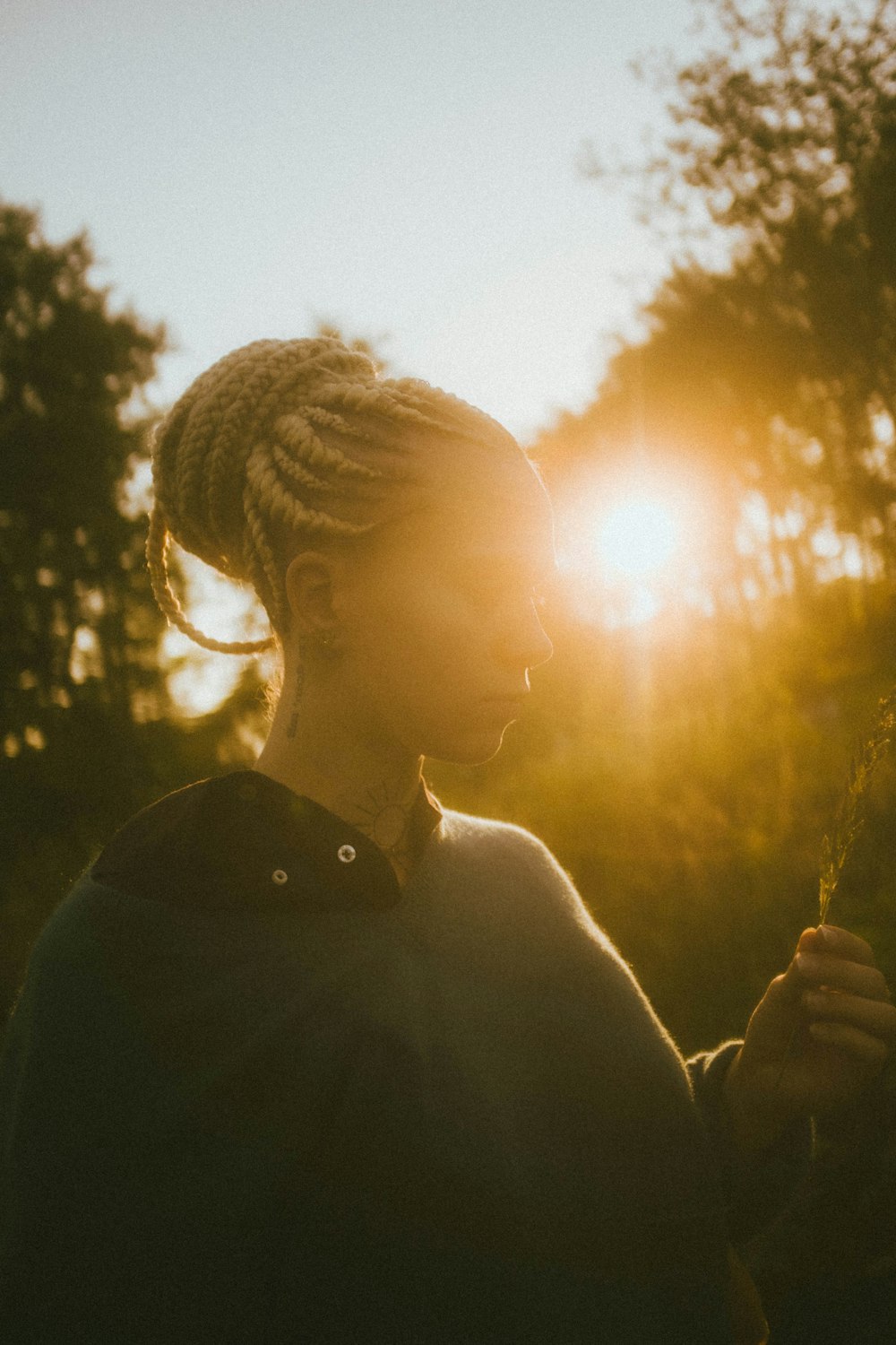 woman in black shirt standing during sunset