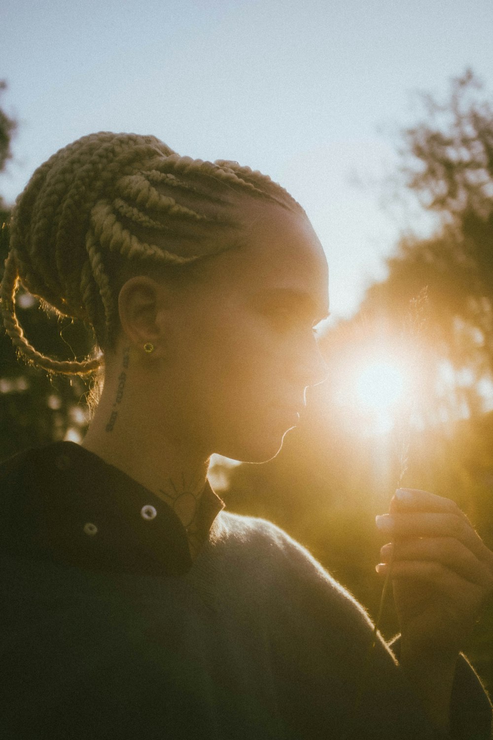 woman in black shirt holding sun