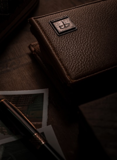 brown leather wallet on brown wooden table