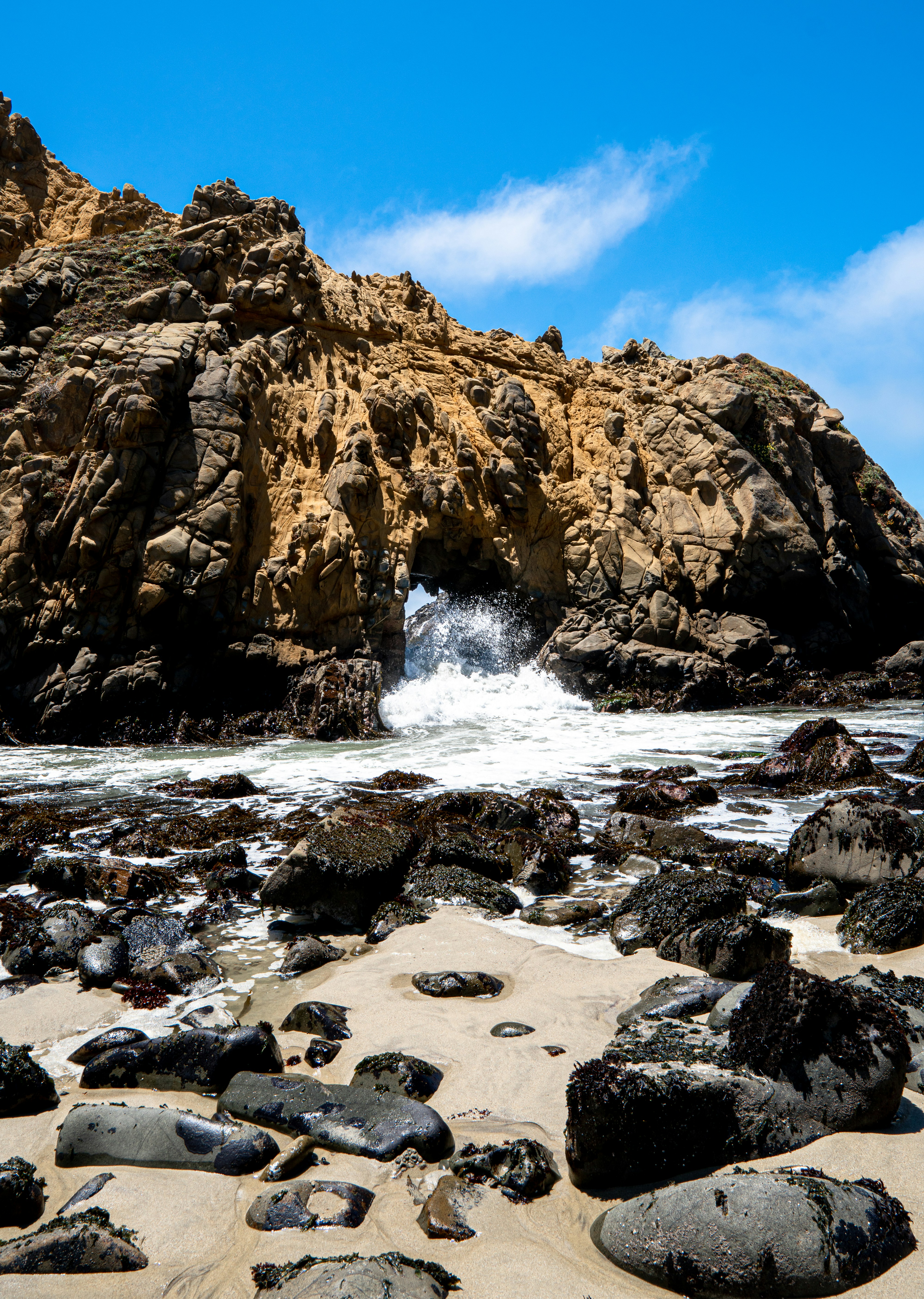 brown rock formation near body of water during daytime