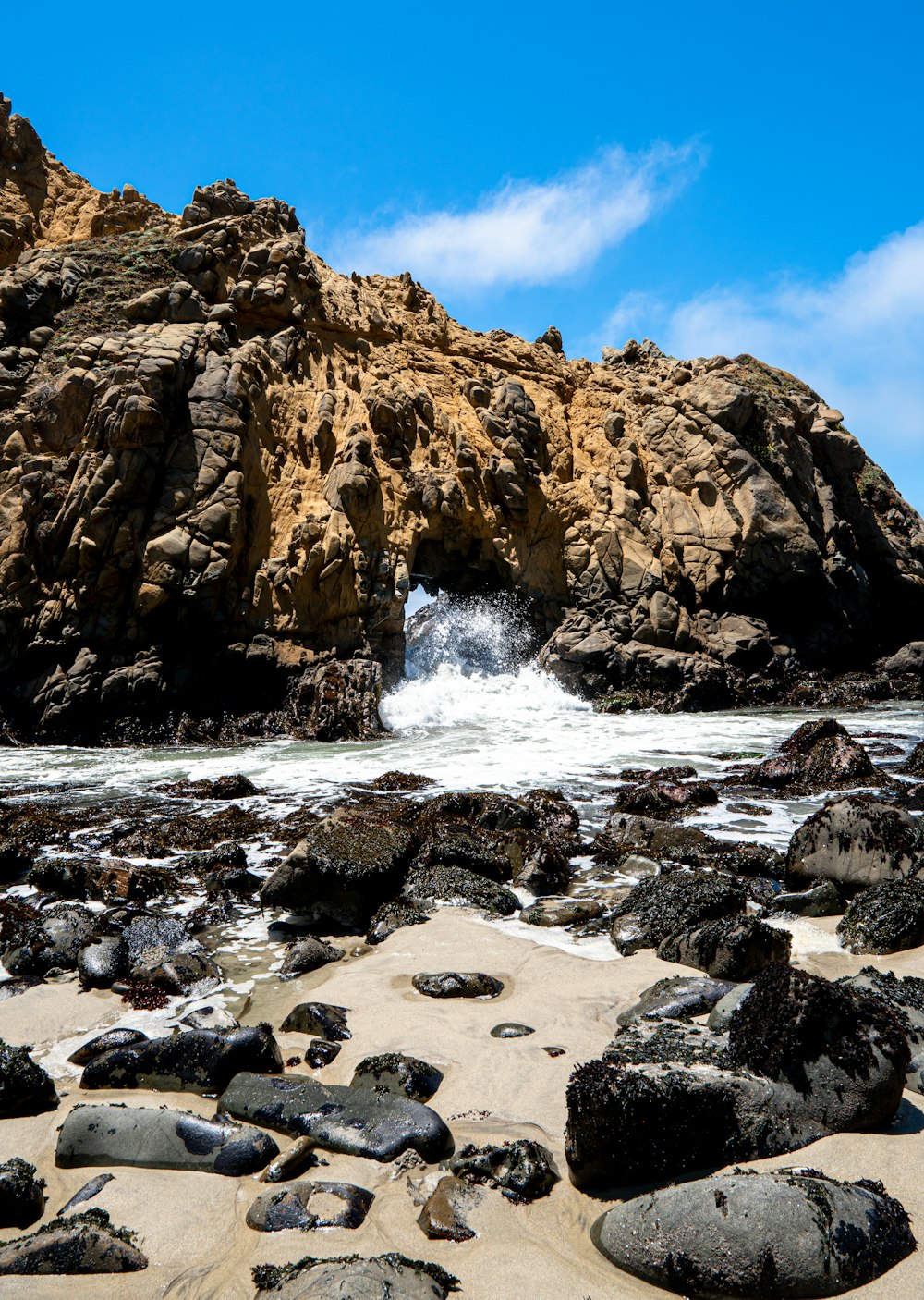 brown rock formation near body of water during daytime