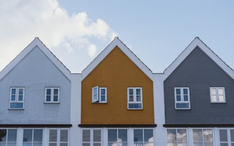 white and brown concrete house under blue sky during daytime