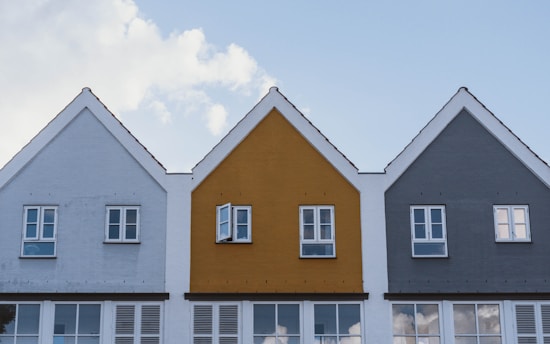 white and brown concrete house under blue sky during daytime