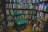 A cozy corner with a mother and child sharing a quiet moment, surrounded by books.