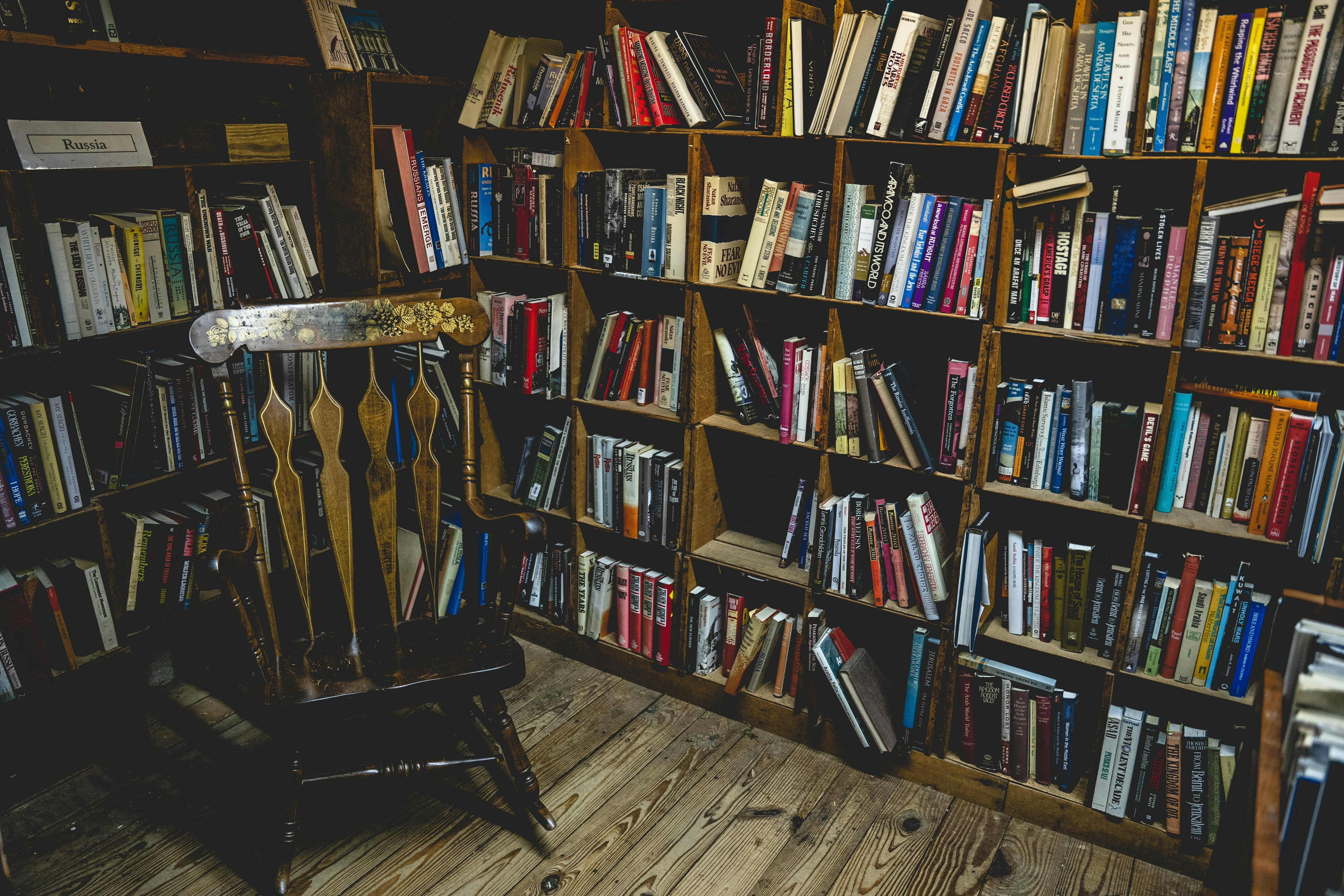 books on brown wooden shelf