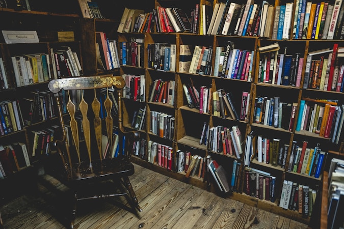 books on brown wooden shelf