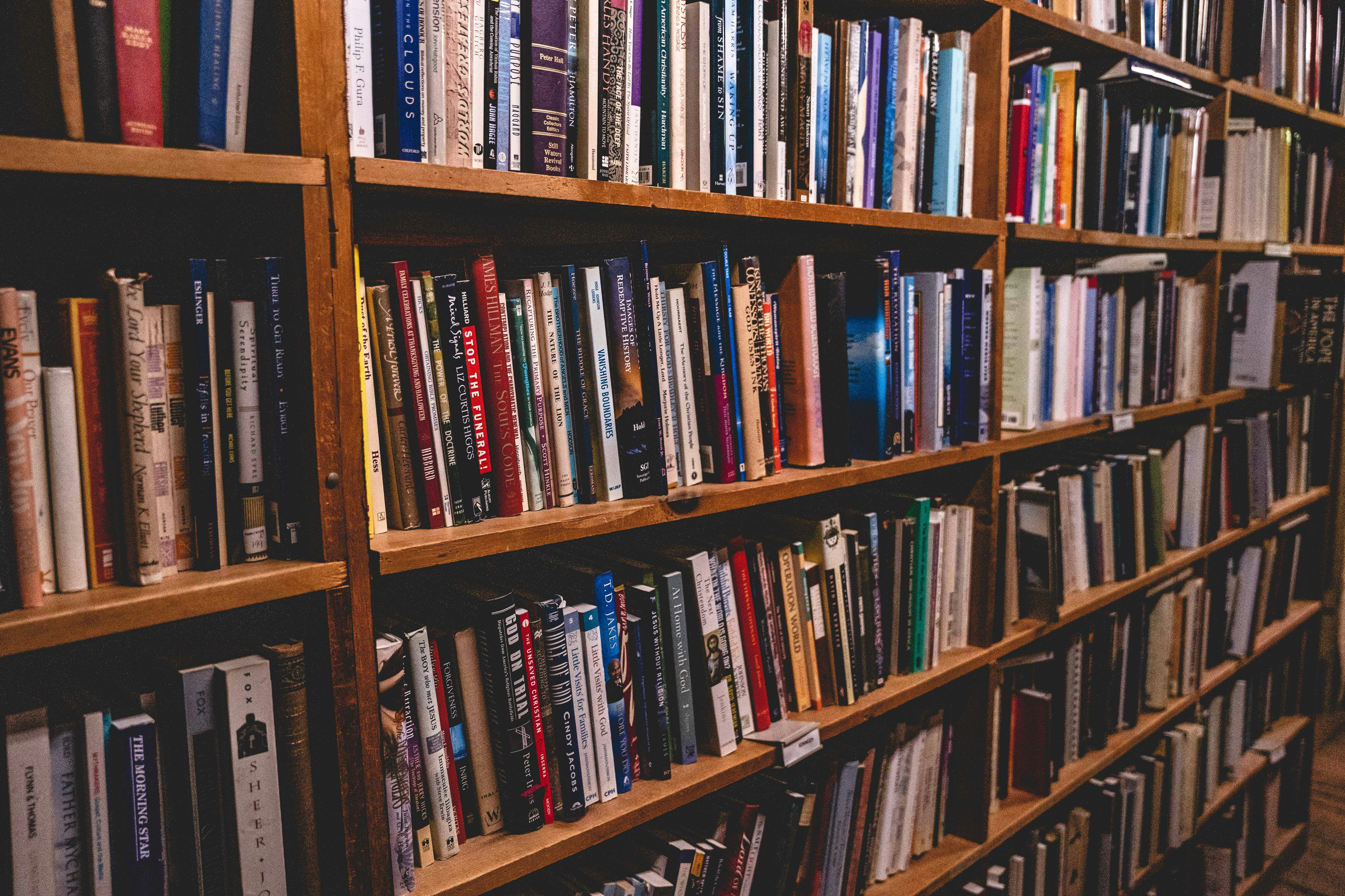 books on brown wooden shelf