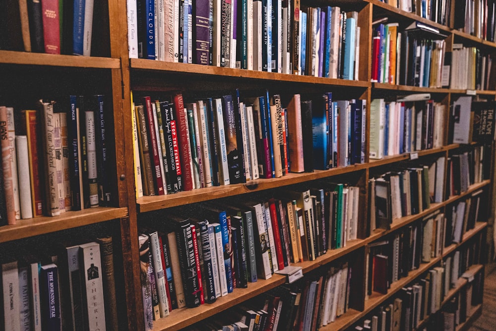 books on brown wooden shelf