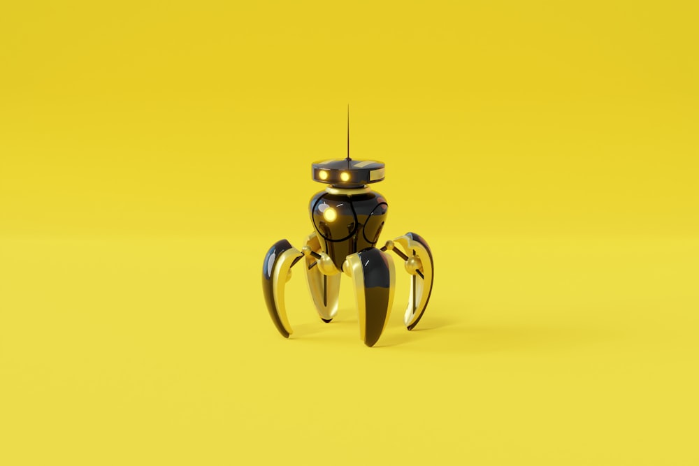 yellow and silver frog figurine