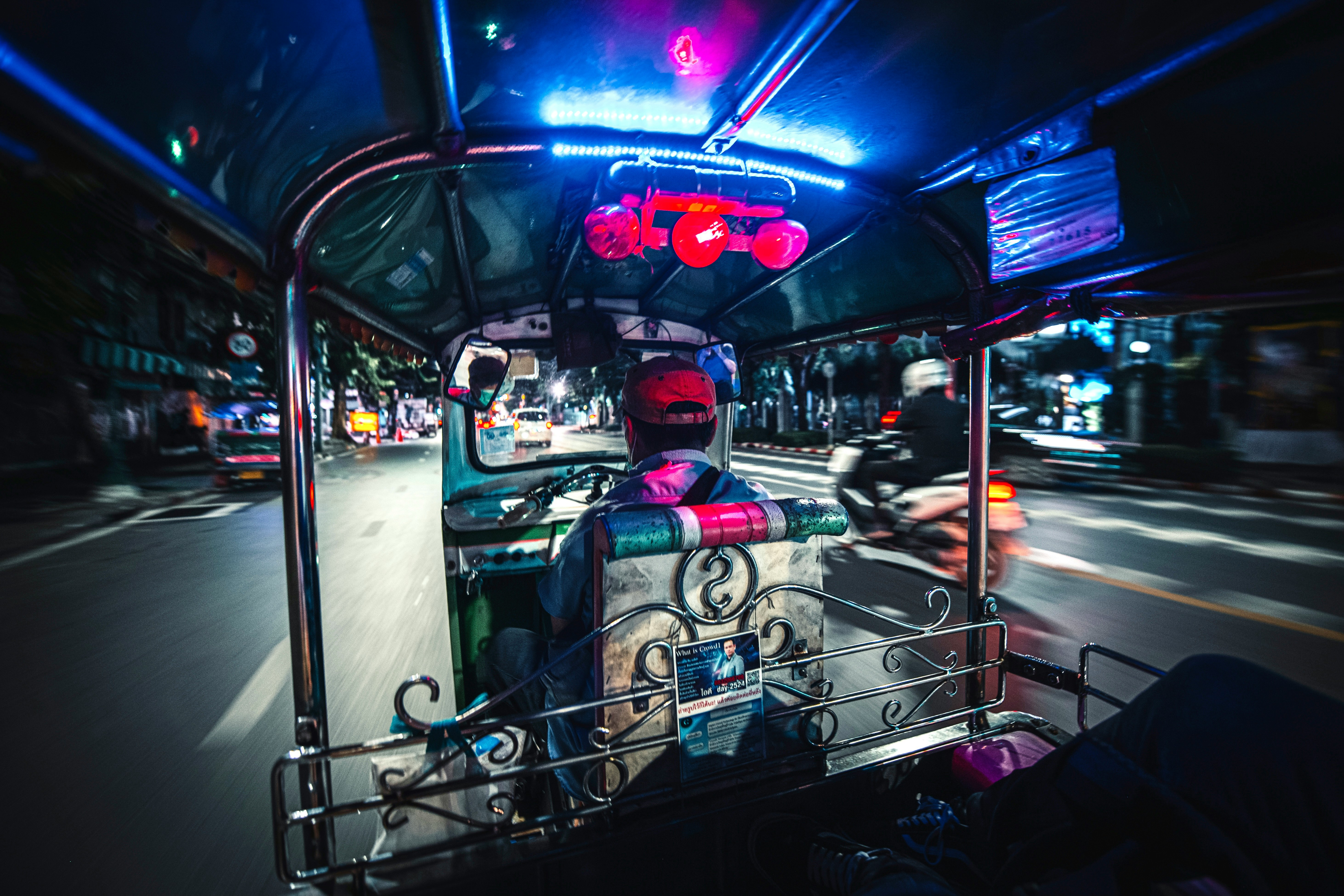 people riding on blue and white car during nighttime