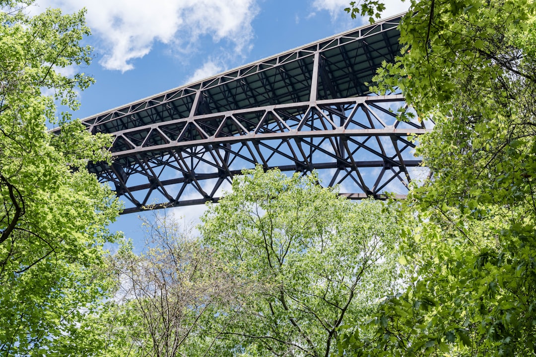black metal frame bridge under blue sky during daytime