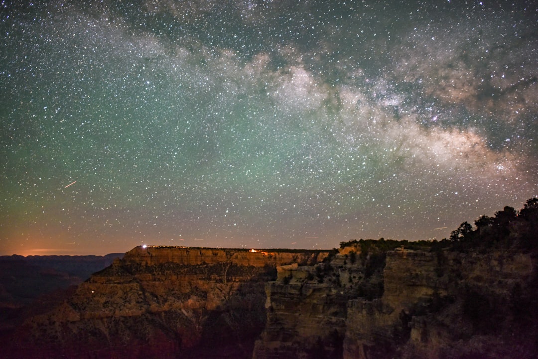 brown rocky mountain under starry night