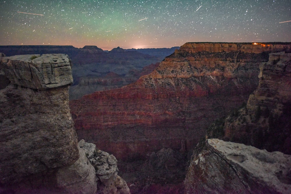 brown rocky mountain under blue sky during night time