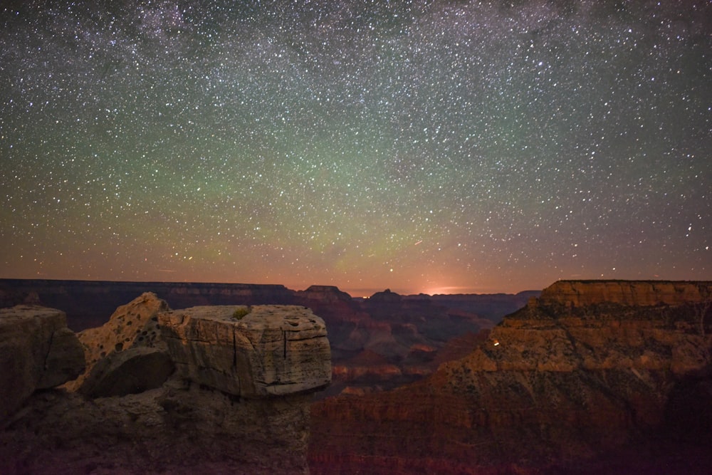 brown rocky mountain under starry night