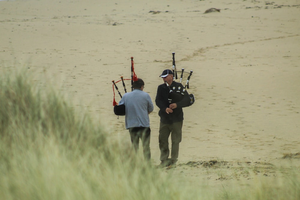 man in red shirt and gray pants holding black and brown rifle