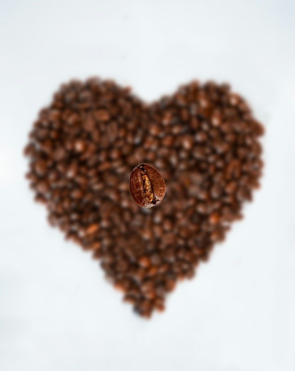 brown coffee beans on white surface