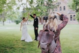 woman in red and black floral dress carrying black leather shoulder bag