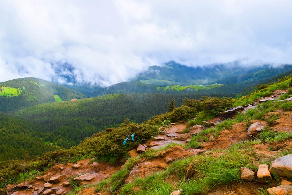 a man hiking up a mountain trail in the mountains