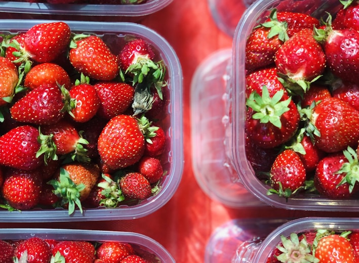 red strawberries in clear plastic container