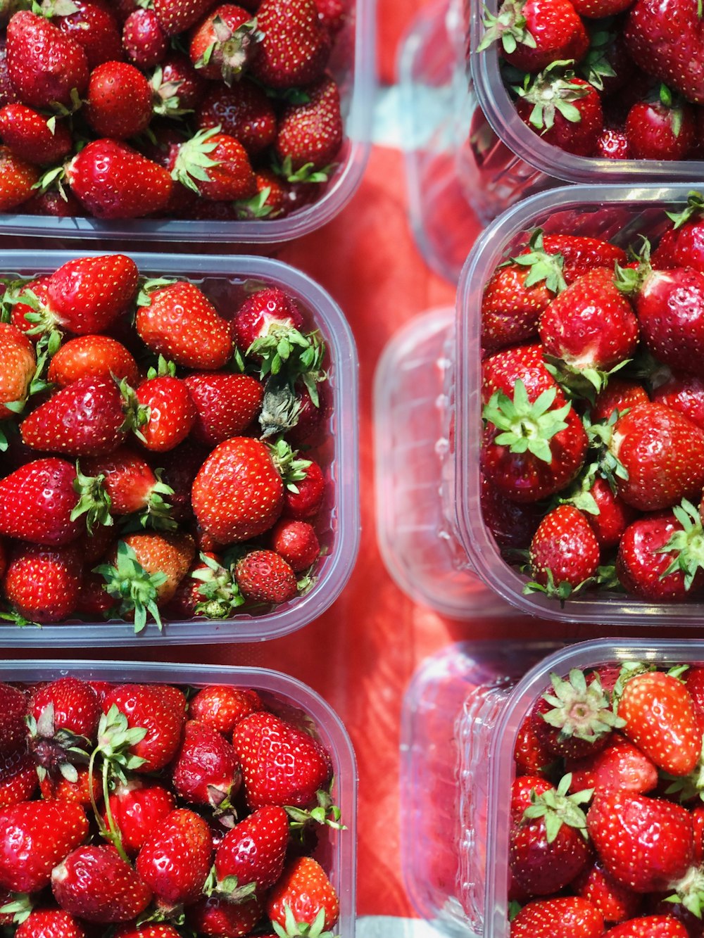 red strawberries in clear plastic container