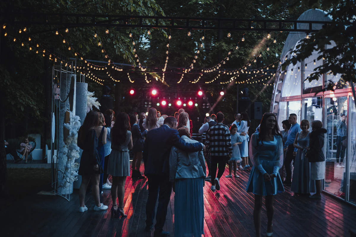 Wedding reception with mixed family generations around lit tables.