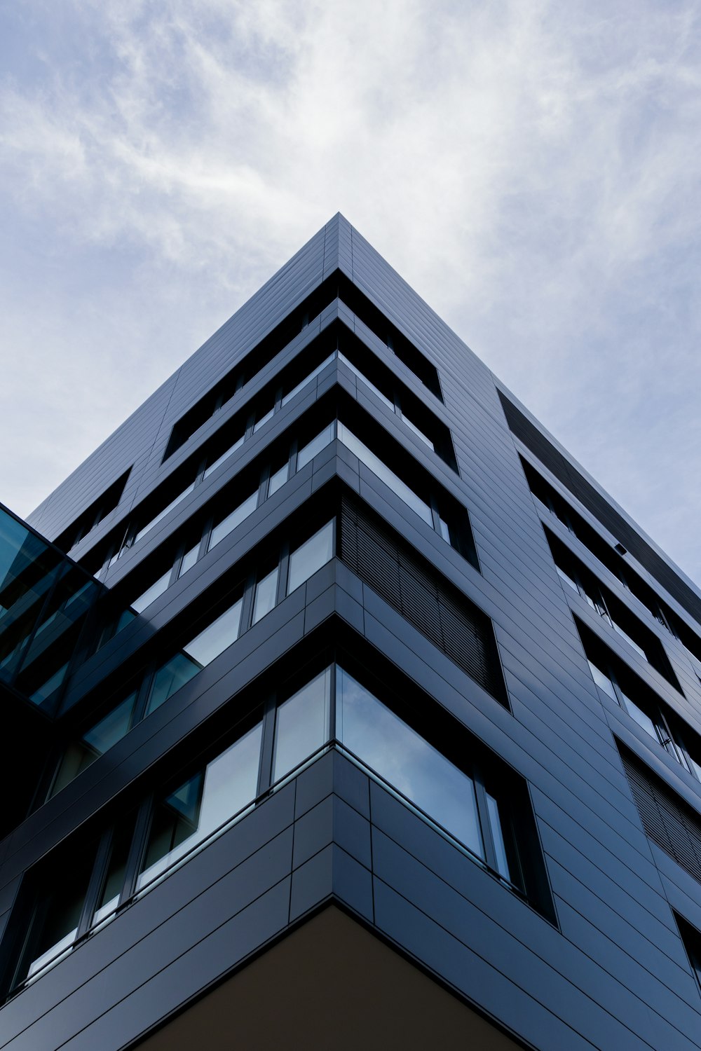 blue and white concrete building under white clouds during daytime