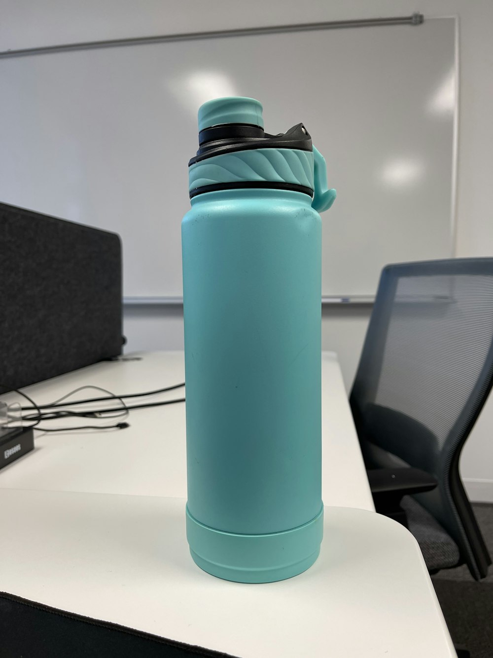 blue and black sports bottle on white table