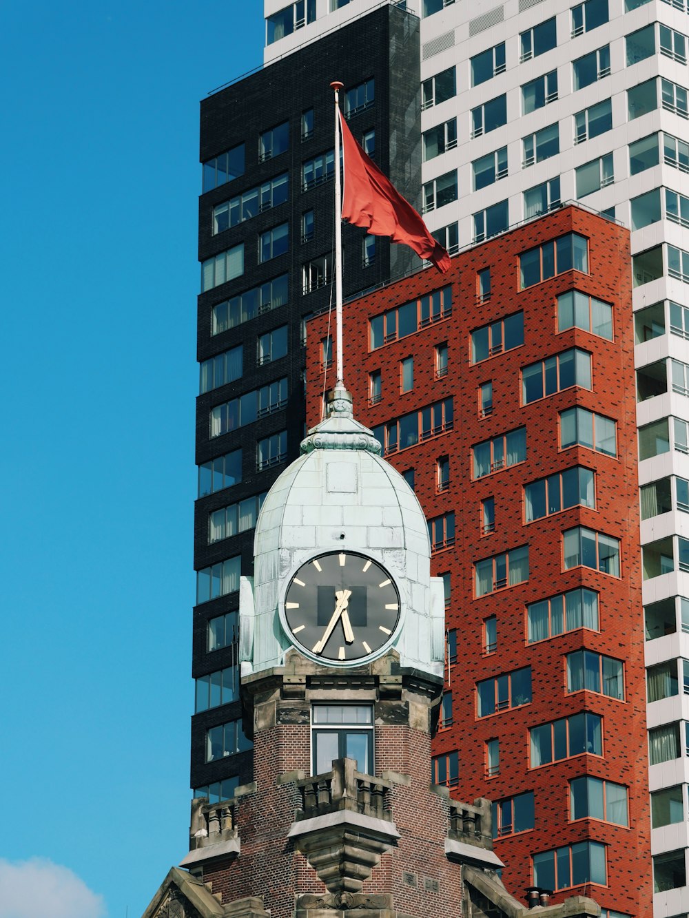 red flag on top of brown building