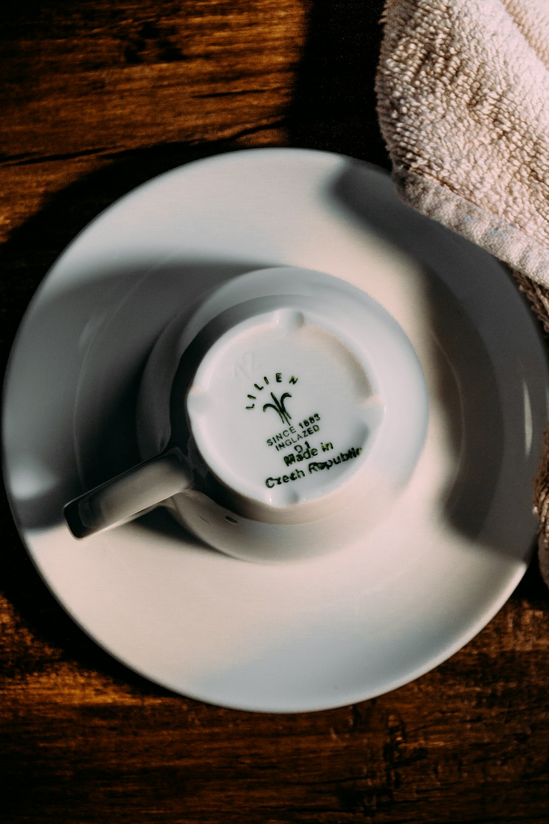 white ceramic mug on white ceramic plate