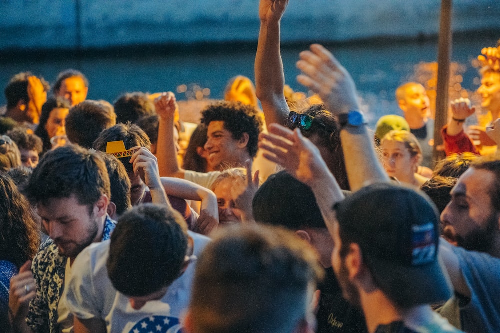 people raising their hands during daytime