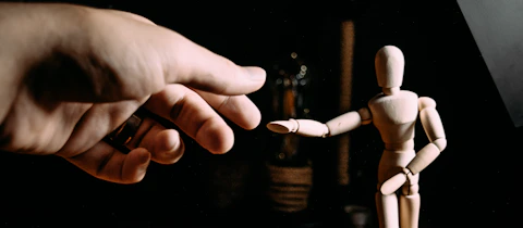 person holding white and brown cigarette stick