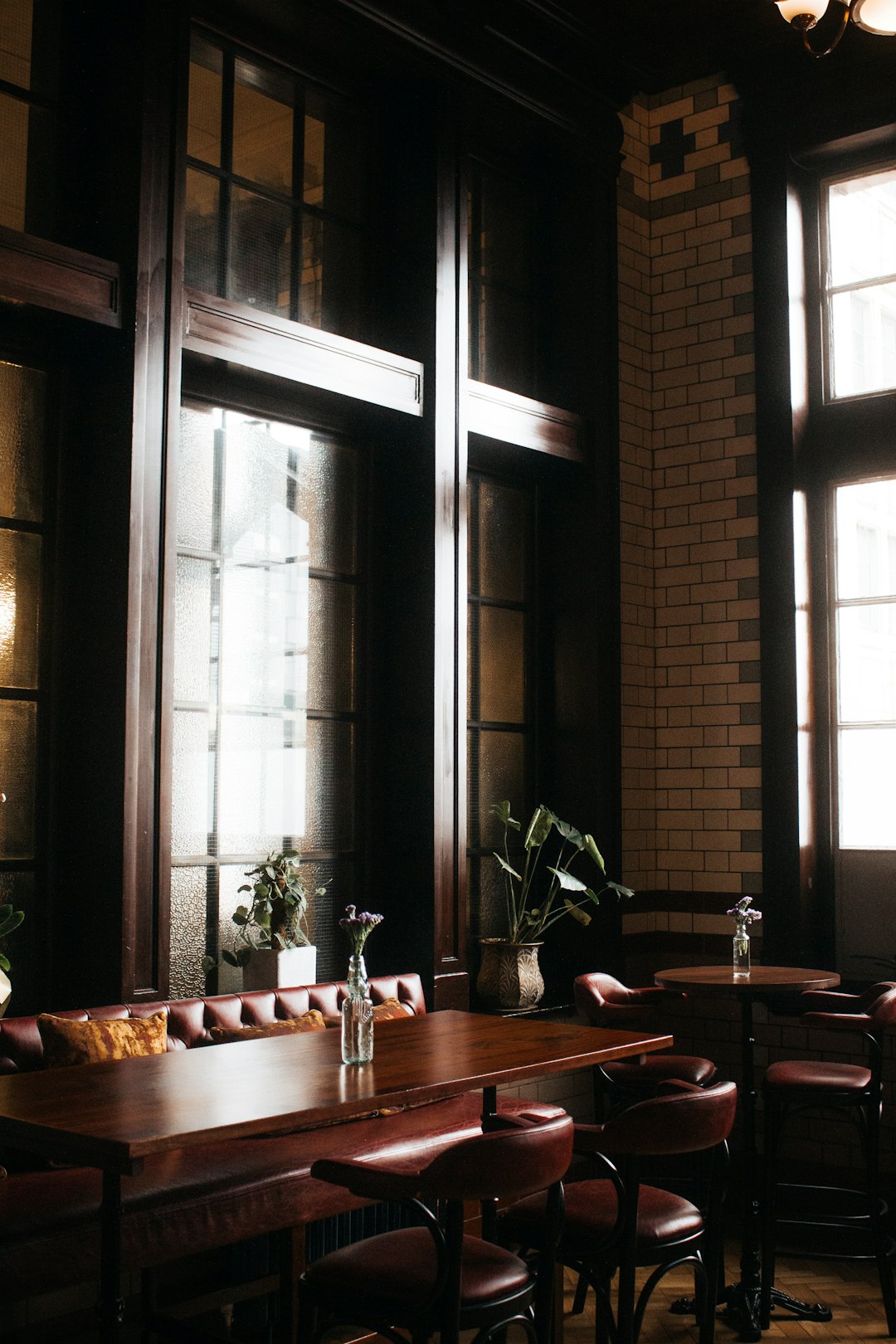 brown wooden table near window