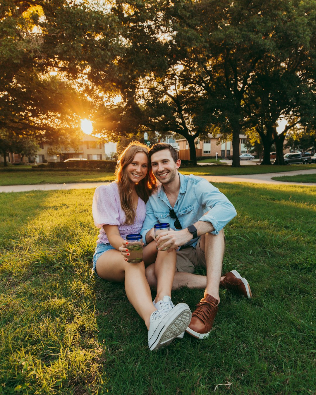 man and woman sitting on green grass field during daytime