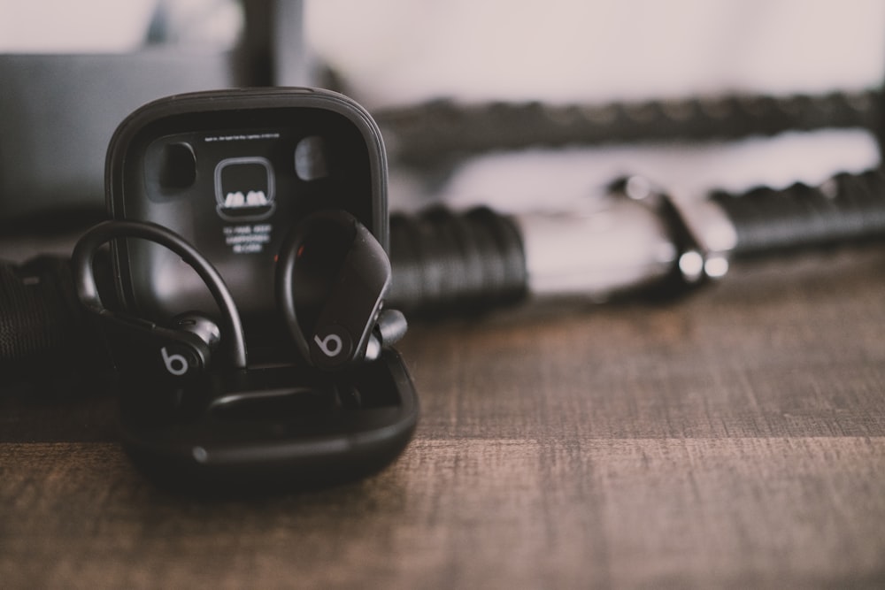 black corded headphones on brown wooden table