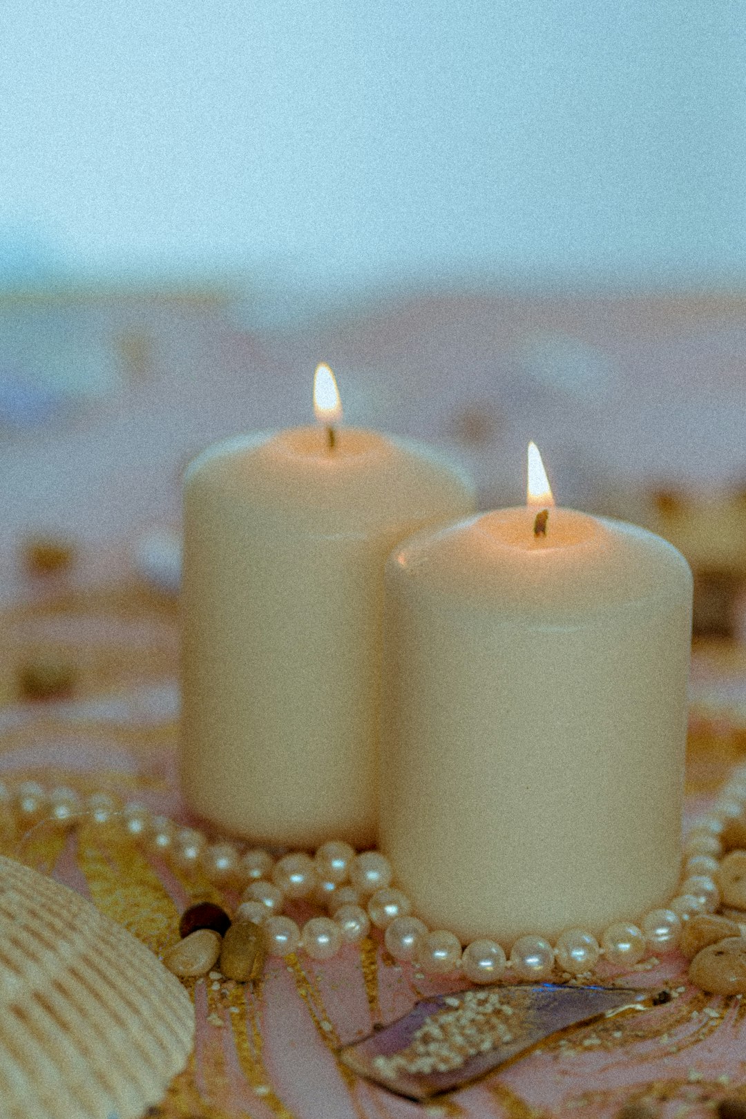 white pillar candles on brown table