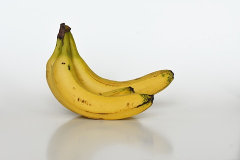 yellow bananas on white table