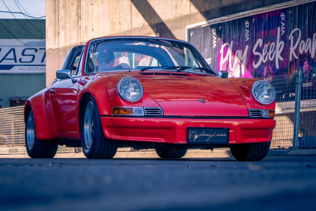 red porsche 911 parked on road during daytime