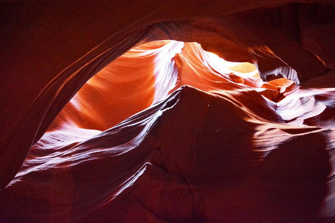 brown and black cave with sun rays