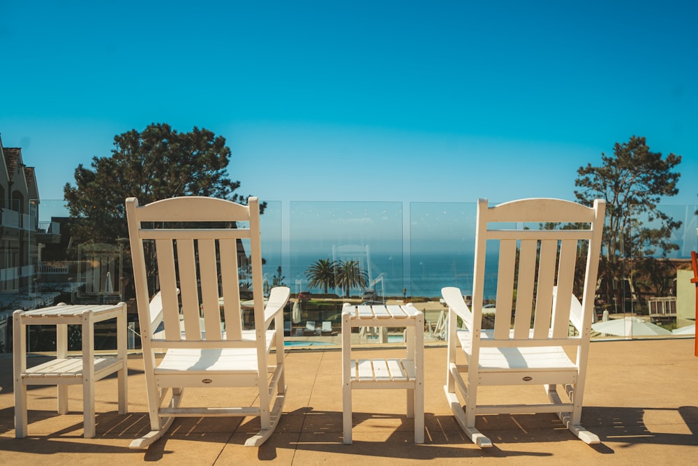 white wooden chairs on brown wooden deck during daytime